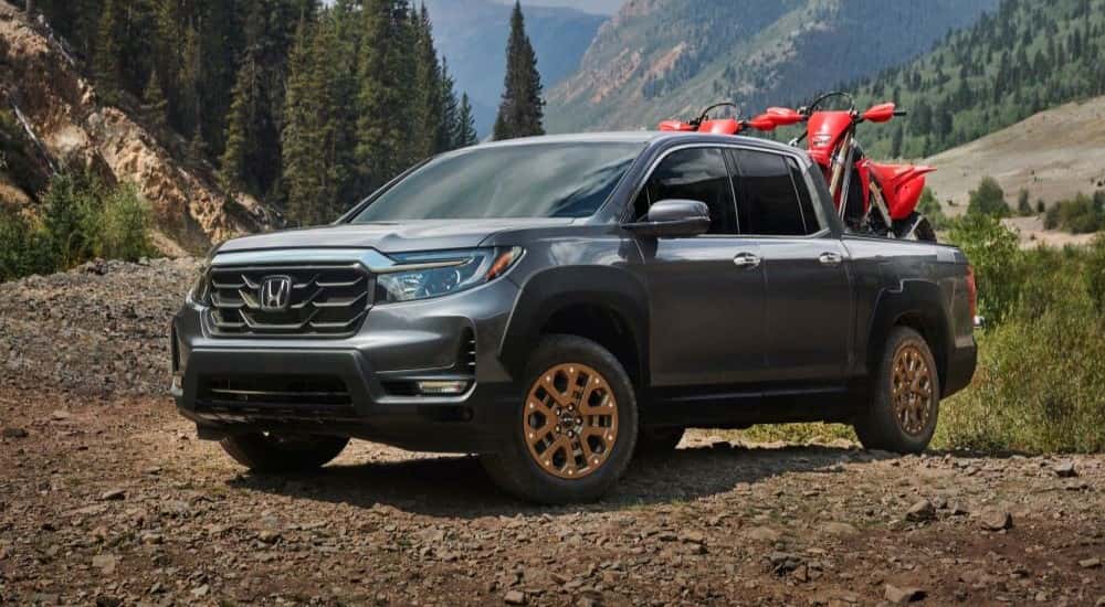 Grey 2021 Honda Ridgeline with dirt bikes in the bed