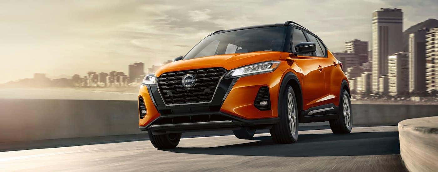 Front of a 2023 Nissan Kicks driving away from city.