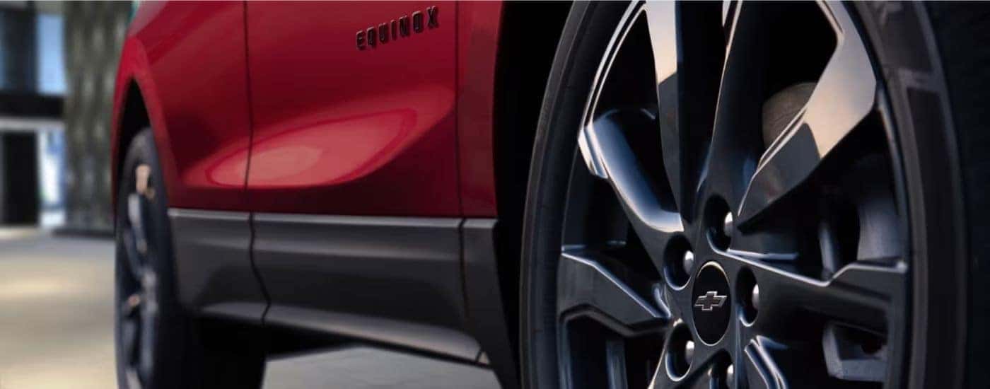 Black wheels on a red 2023 Chevy Equinox RS.
