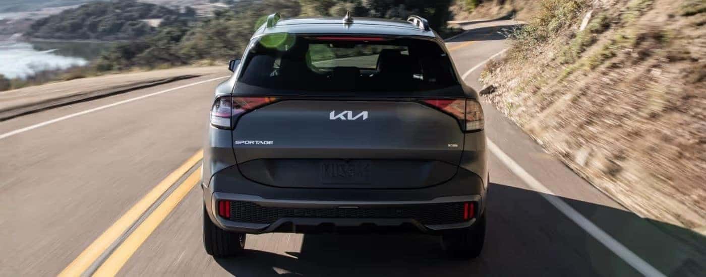 Grey 2023 Kia Sportage X-Line driving on a highway.