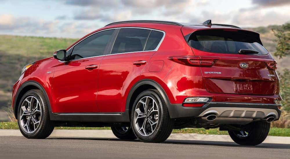 A red 2020 Kia Sportage shown from rear parked.