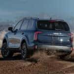 Blue 2023 Kia Telluride X Pro drifting off road.