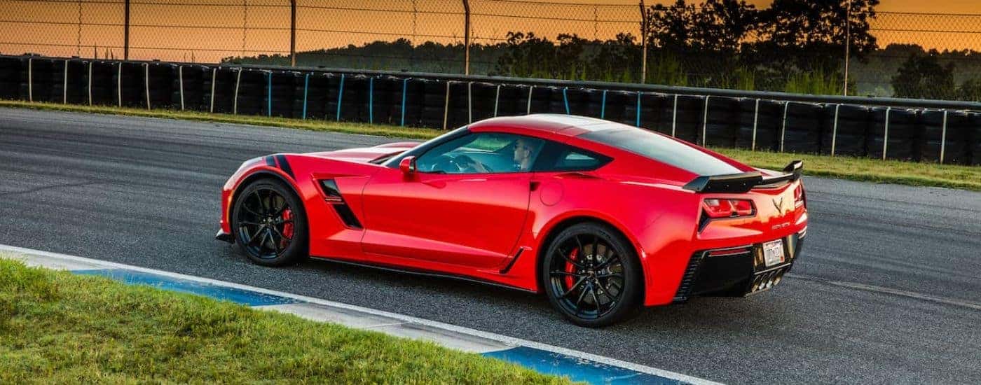 A red 2017 Chevy Corvette Grand Sport C7 on a racetrack.