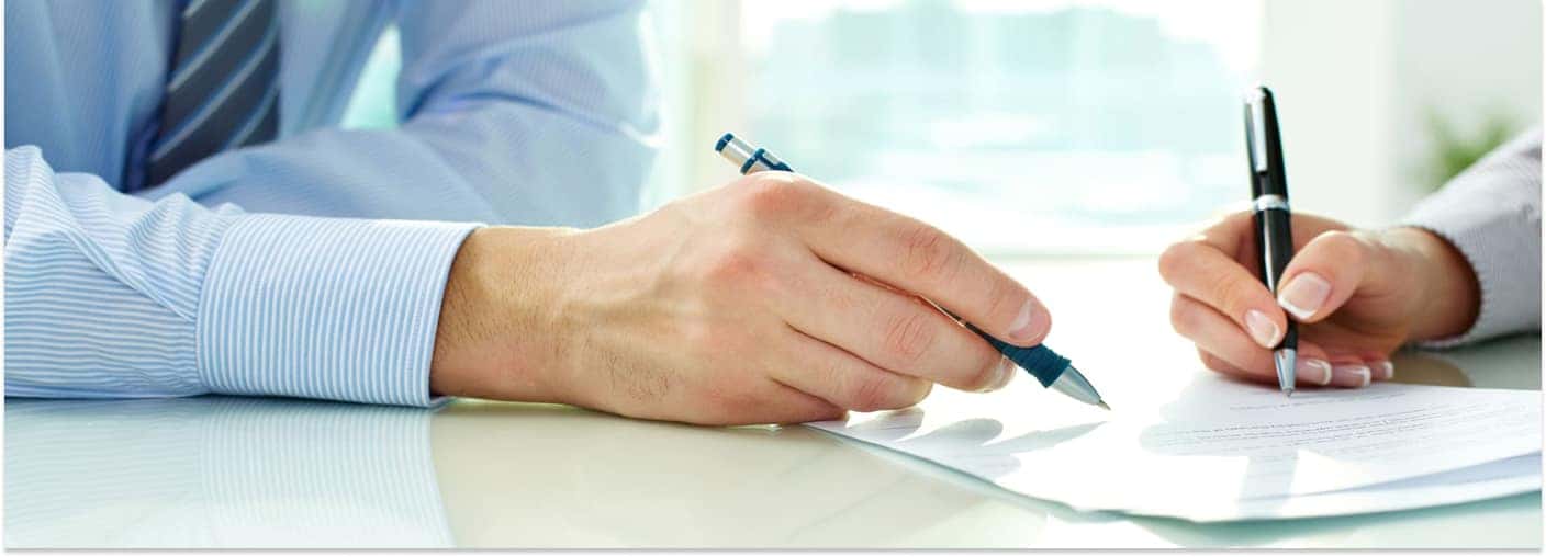 Two People Reviewing Documentation on a Table