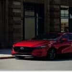 Bright Red 2026 MAZDA3 Hatchback Parked on Street