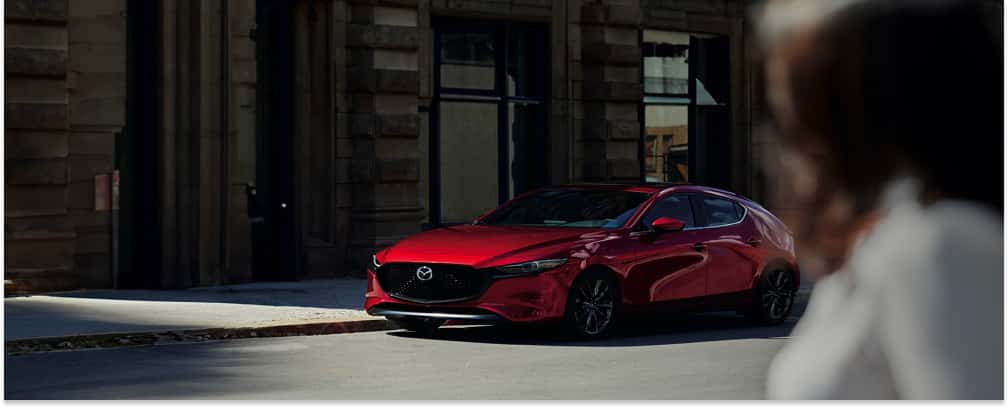 Bright Red 2026 MAZDA3 Hatchback Parked on Street