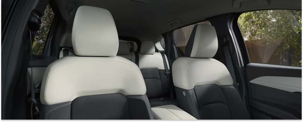 Interior seating of a 2026 Mazda CX-5 featuring two-tone Pure White and black upholstered seats.