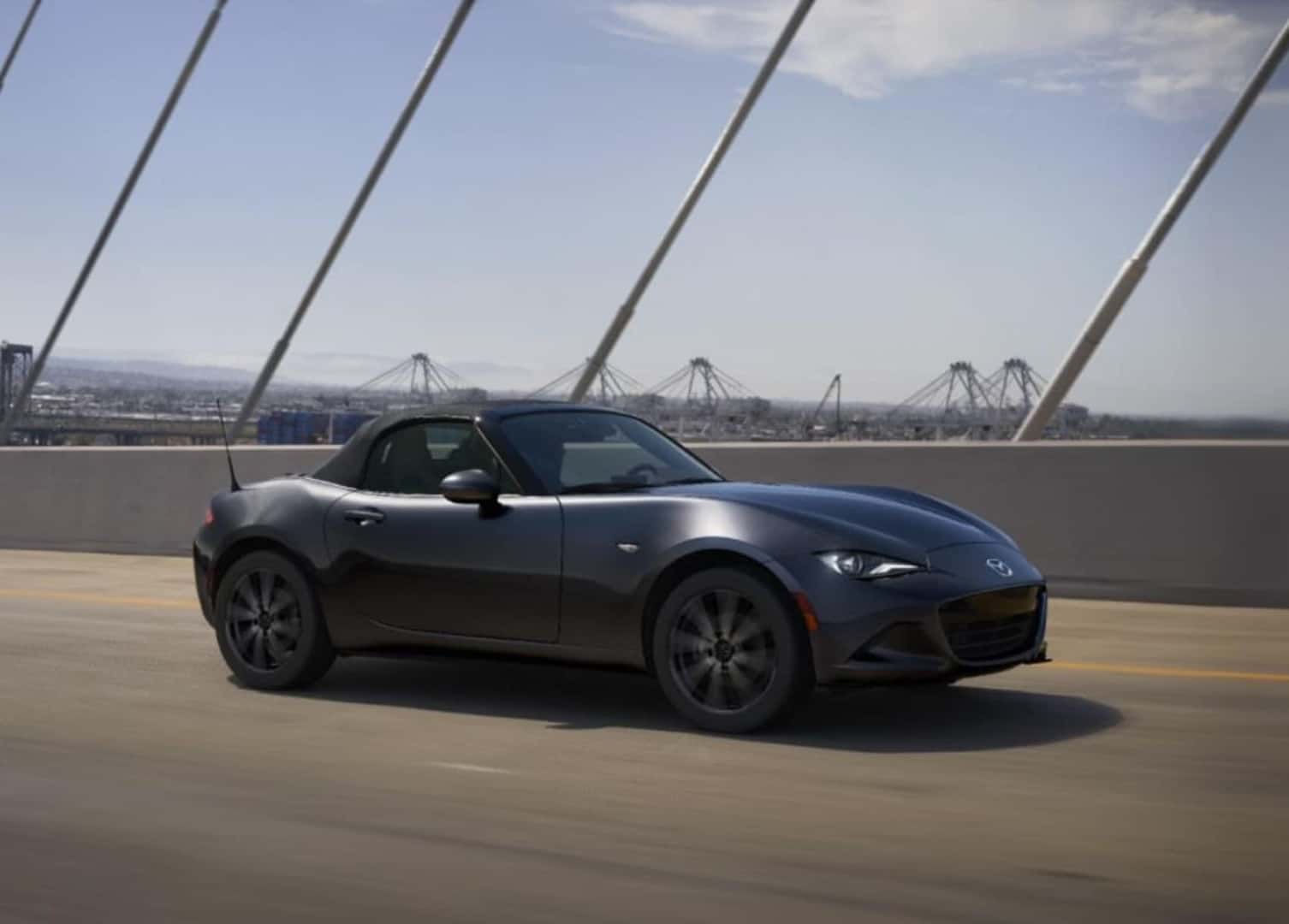 MAZDA MX-5 Miata driving on a bridge