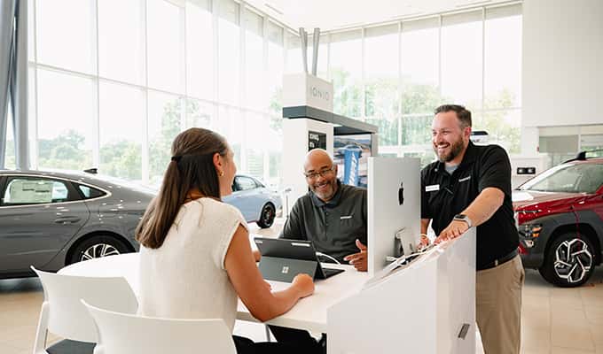 young woman talking to customer specialists at Walser Hyundai about great limited time offers