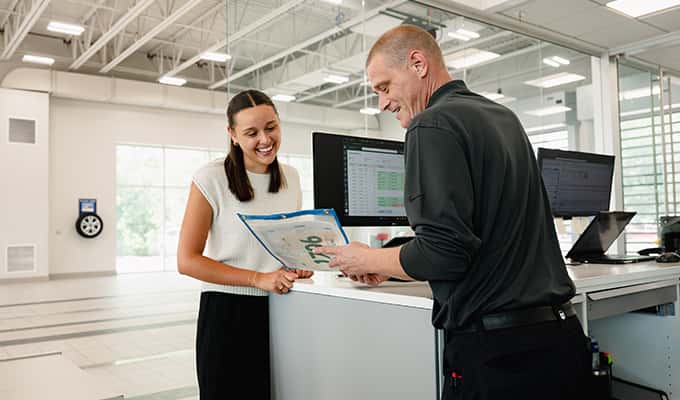 Young woman and service manager at Walser Hyundai discussing what is covered by walsercare