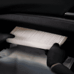 A new cabin air filter being installed.