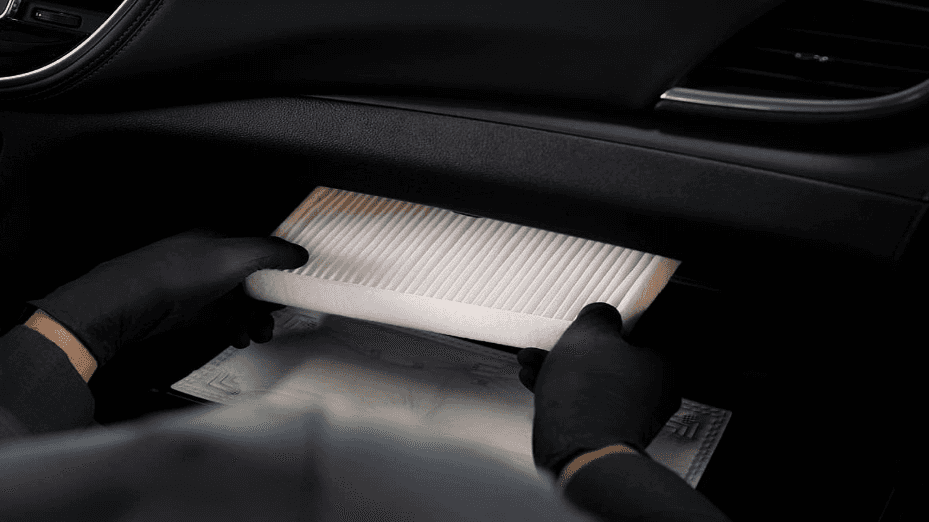 A new cabin air filter being installed.