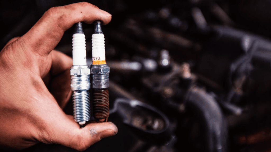 A comparison between a new and old spark plug.