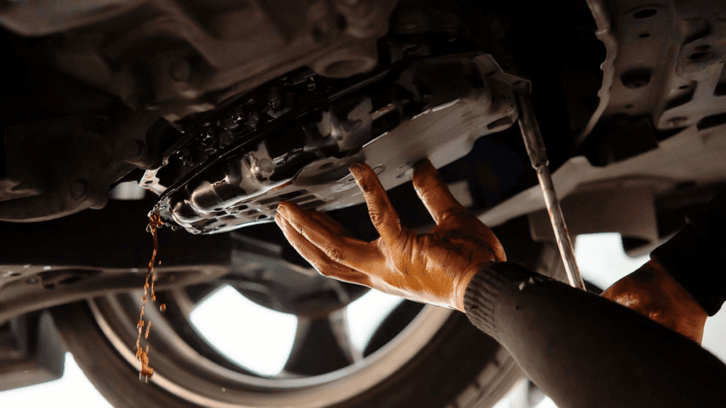 Old transmission fluid being drained as part of a transmission fluid exchange.
